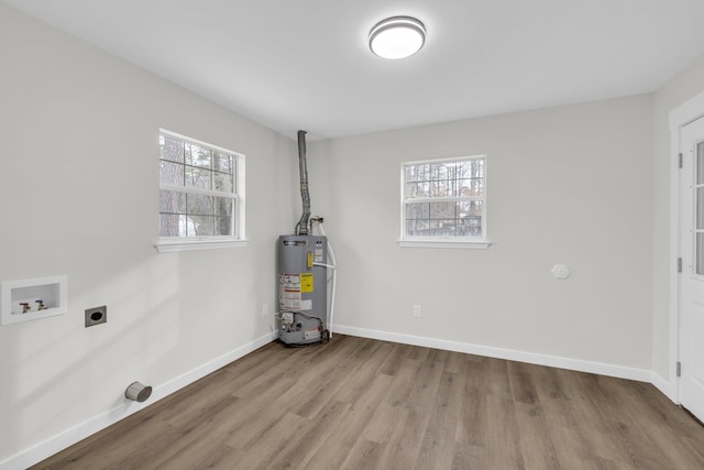 laundry area with water heater, electric dryer hookup, washer hookup, and light hardwood / wood-style flooring