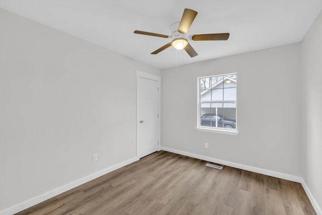 unfurnished room with light hardwood / wood-style flooring and ceiling fan