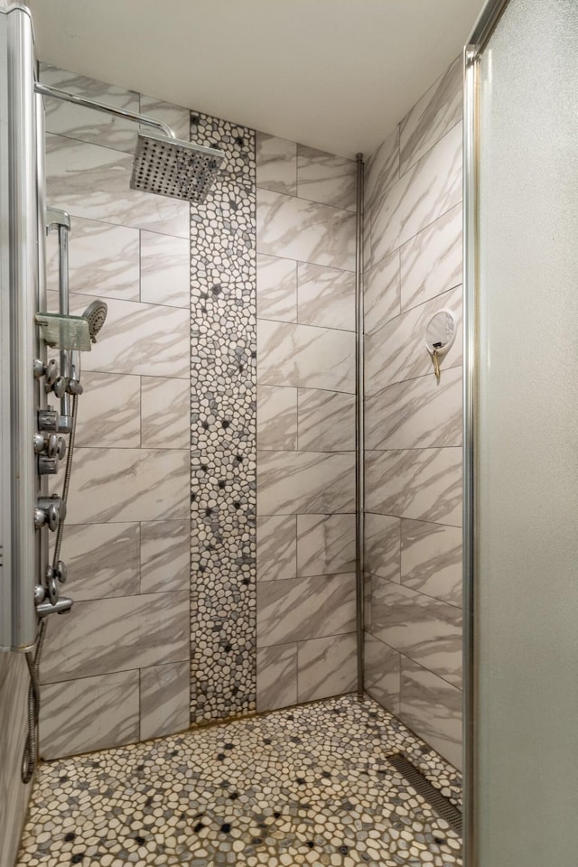 bathroom with a tile shower