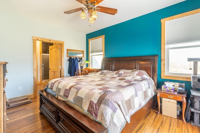 bedroom with dark wood-type flooring, ceiling fan, and multiple windows