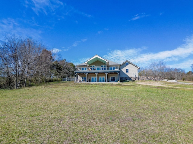 view of front of property featuring a deck and a front lawn