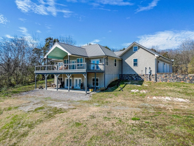 rear view of property with a yard, a patio area, and a deck