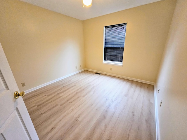 spare room featuring light hardwood / wood-style floors