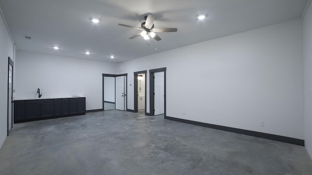 empty room with ceiling fan and sink