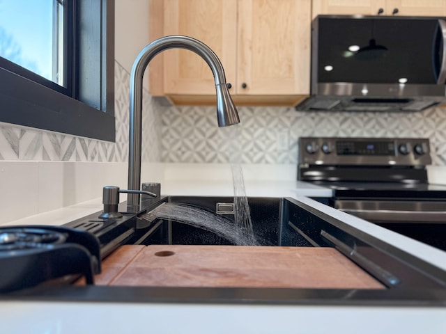 details with light brown cabinetry and tasteful backsplash