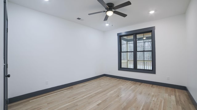 spare room with ceiling fan and light wood-type flooring