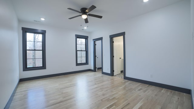 empty room with ceiling fan and light wood-type flooring