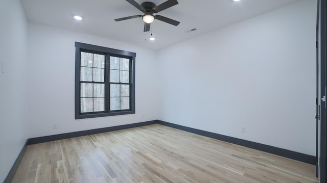 spare room featuring ceiling fan and light hardwood / wood-style floors