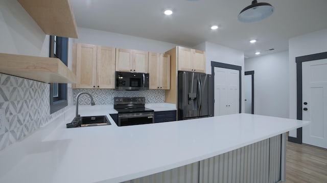 kitchen with light brown cabinetry, sink, decorative backsplash, kitchen peninsula, and stainless steel appliances