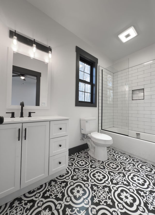 full bathroom featuring bath / shower combo with glass door, vanity, tile patterned floors, and toilet