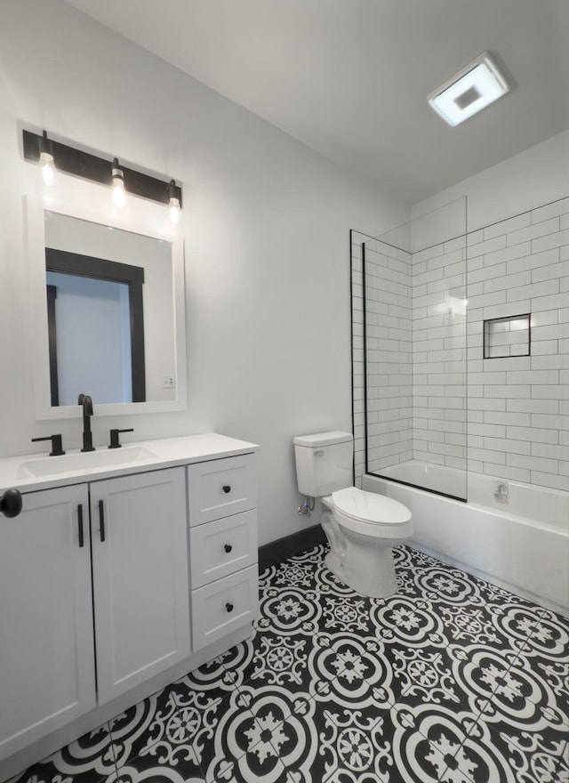 full bathroom featuring tile patterned flooring, vanity, toilet, and tiled shower / bath