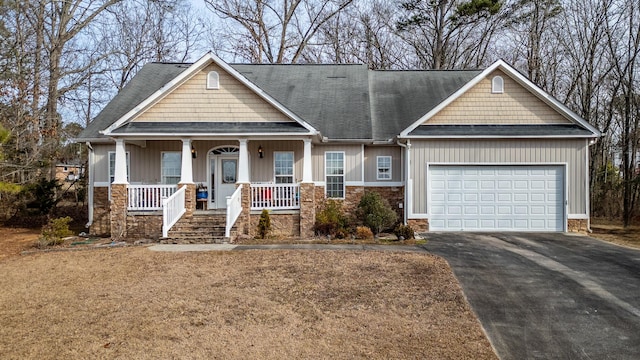 craftsman-style house featuring a porch and a garage