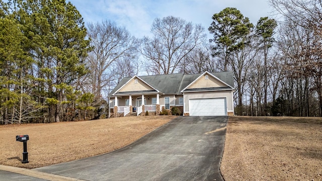 view of front of home with a garage and a porch