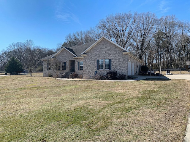 view of front of home with a garage and a front lawn