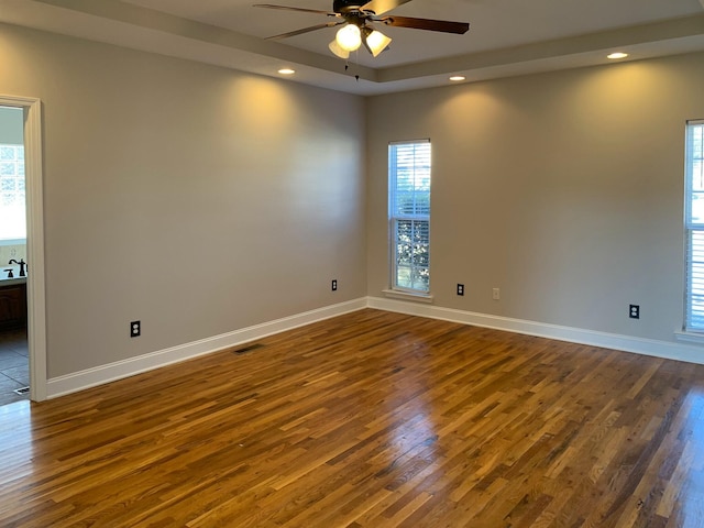 unfurnished room with dark wood-type flooring, ceiling fan, and sink