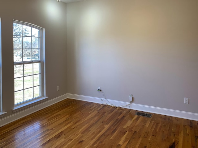 spare room with dark hardwood / wood-style floors