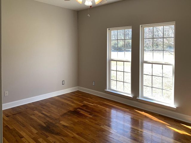 empty room featuring ceiling fan and dark hardwood / wood-style flooring