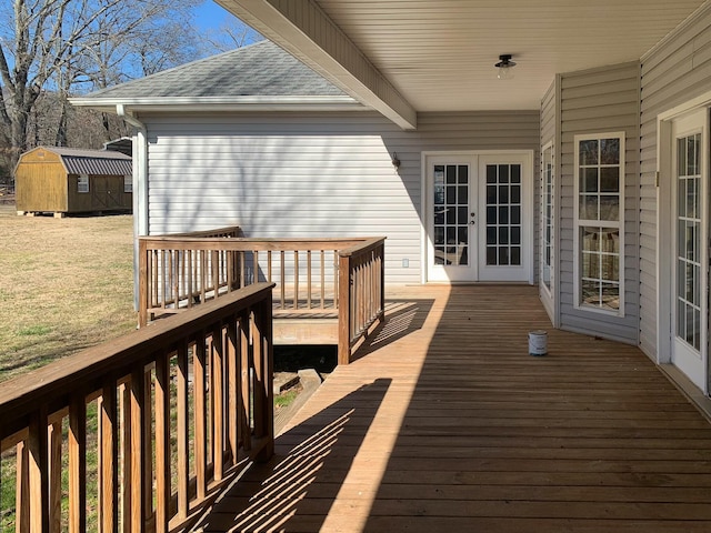 wooden terrace with a storage unit and french doors