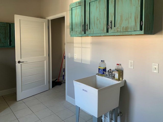 kitchen with sink, light tile patterned flooring, and green cabinets