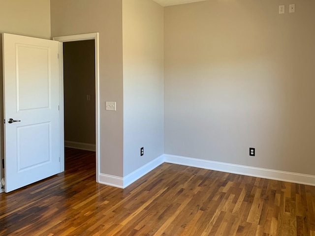 spare room featuring dark wood-type flooring