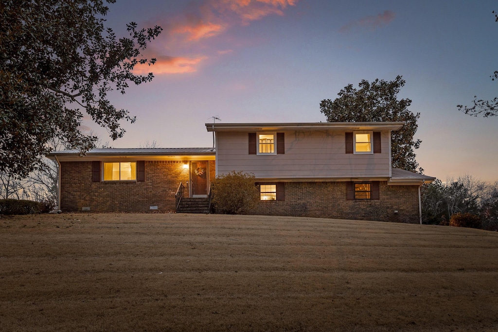 tri-level home with a lawn