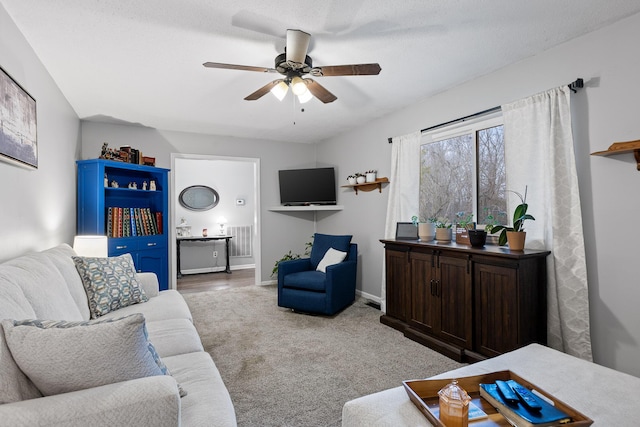 living room featuring light carpet and ceiling fan