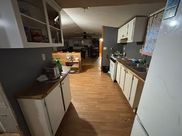 kitchen featuring sink, white electric range, ceiling fan, white cabinetry, and light wood-type flooring