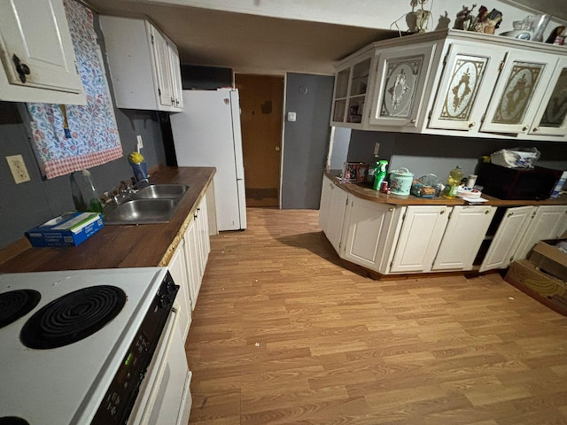 kitchen featuring white cabinetry, white appliances, sink, and light hardwood / wood-style flooring