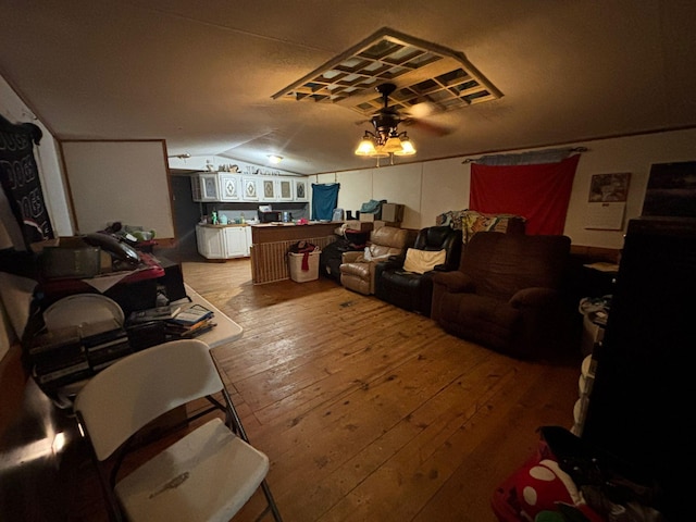 living room with vaulted ceiling and hardwood / wood-style floors