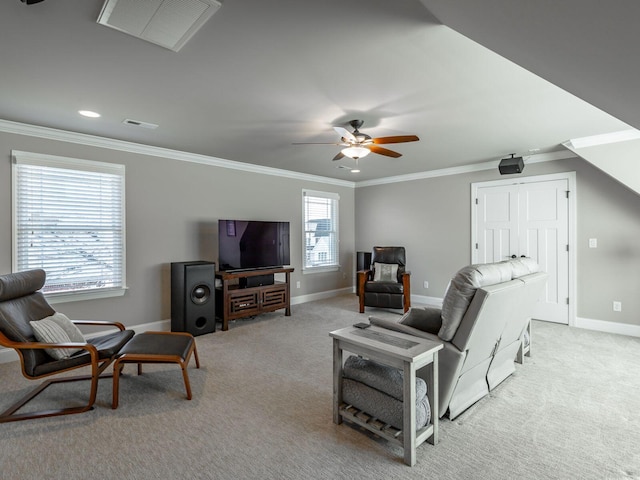 carpeted living room with crown molding and ceiling fan