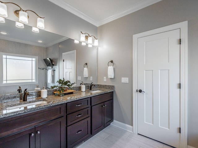 bathroom featuring crown molding and vanity