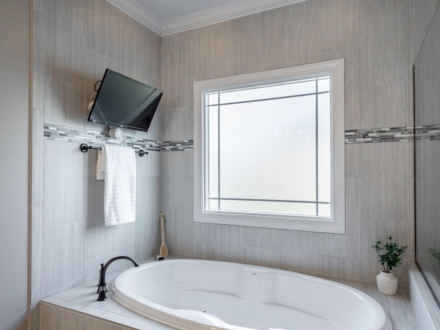 bathroom with crown molding and tiled tub