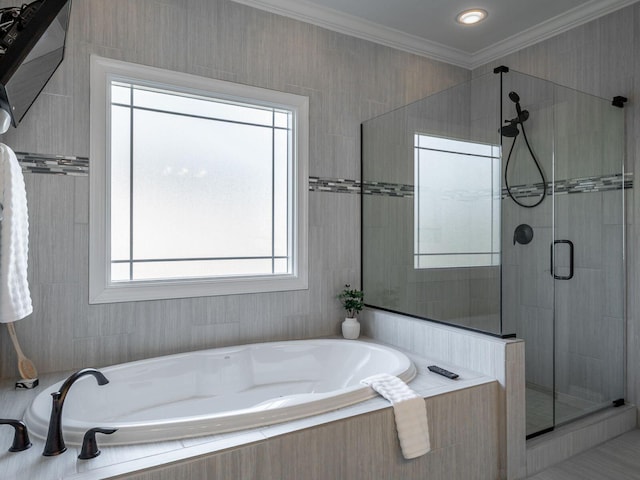 bathroom with crown molding and separate shower and tub