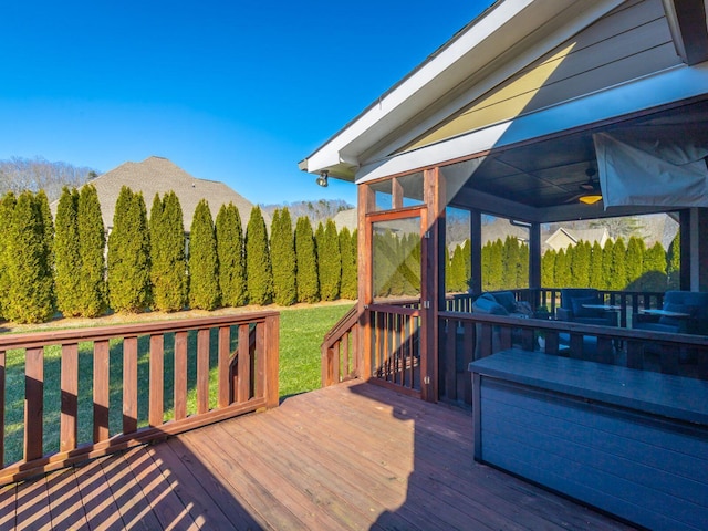 wooden terrace with a yard, a sunroom, and ceiling fan