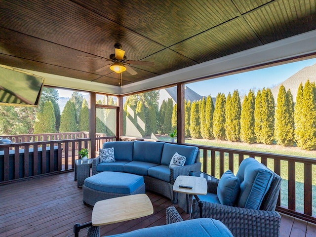 wooden terrace featuring outdoor lounge area and ceiling fan