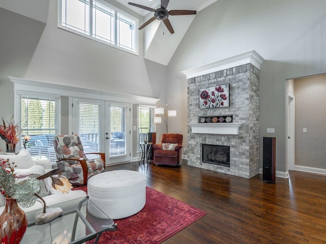 living room featuring plenty of natural light, dark hardwood / wood-style floors, a fireplace, and french doors