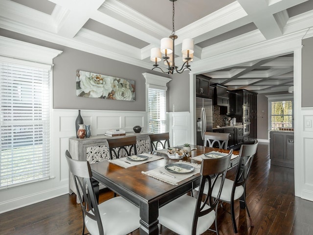 dining area with dark wood-type flooring, beam ceiling, and a chandelier