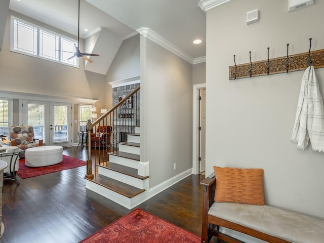 interior space featuring hardwood / wood-style flooring, ornamental molding, a high ceiling, ceiling fan, and french doors