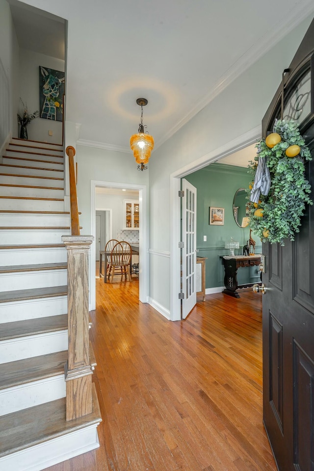 entrance foyer featuring hardwood / wood-style flooring and ornamental molding