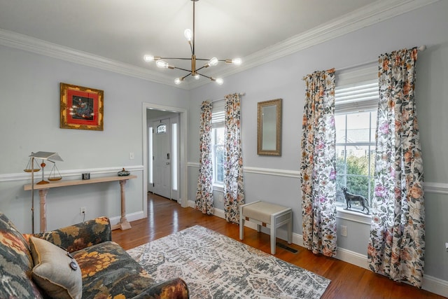 interior space featuring hardwood / wood-style flooring, crown molding, and an inviting chandelier