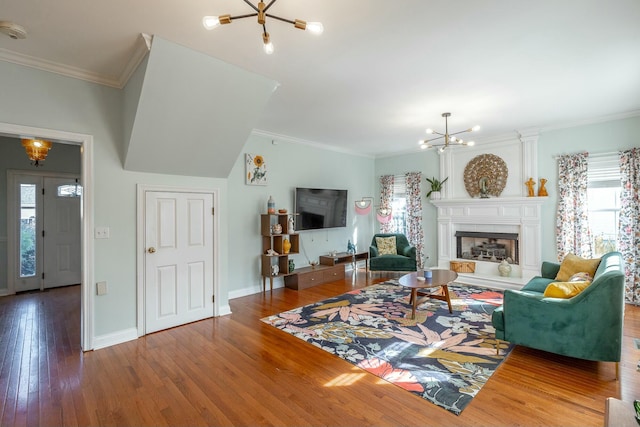 living room featuring ornamental molding, hardwood / wood-style floors, and a notable chandelier