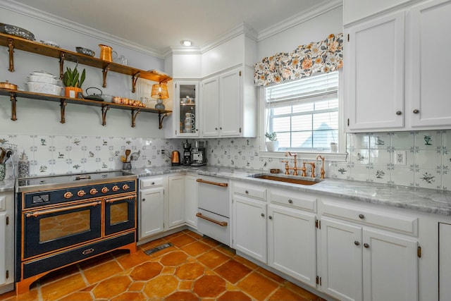 kitchen featuring crown molding, double oven range, sink, and white cabinets