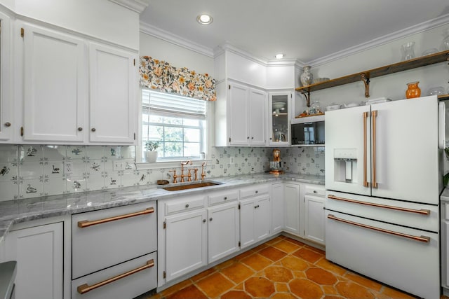 kitchen with high end white refrigerator, sink, white cabinets, decorative backsplash, and crown molding