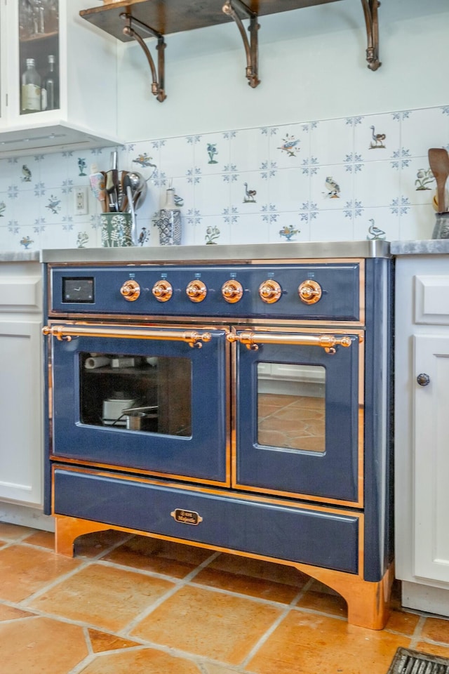 bar featuring white cabinetry, light tile patterned floors, and wall oven