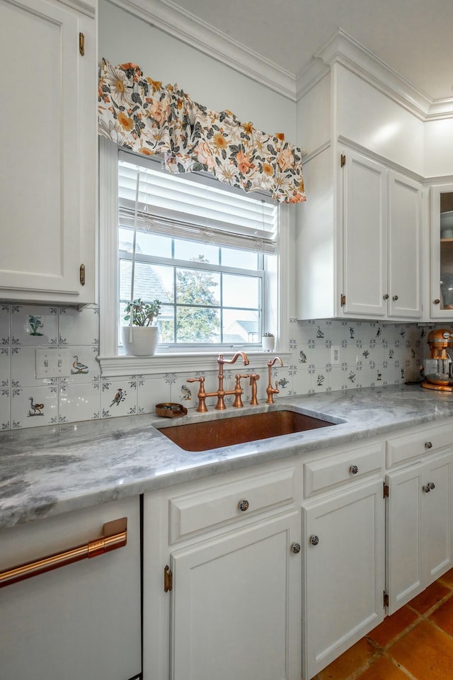 kitchen featuring white cabinetry, ornamental molding, sink, and backsplash