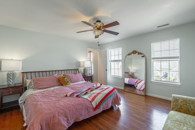 bedroom with dark hardwood / wood-style flooring and ceiling fan