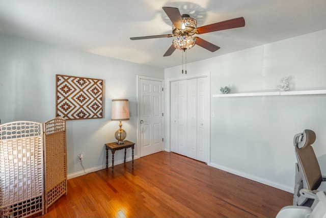 sitting room with wood-type flooring and ceiling fan