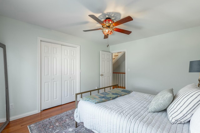 bedroom with wood-type flooring, a closet, and ceiling fan