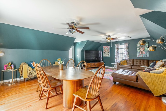 dining area featuring hardwood / wood-style flooring, lofted ceiling, and ceiling fan