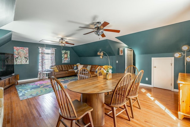 dining room featuring lofted ceiling, light hardwood / wood-style flooring, and ceiling fan